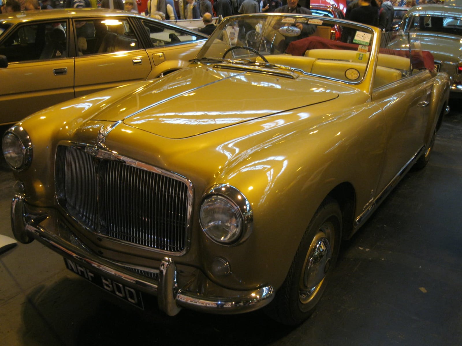 A gold one-off Rover P4 convertible bodied by Pininfarina, front three-quarter view with the hood down, UK registration NHF 800