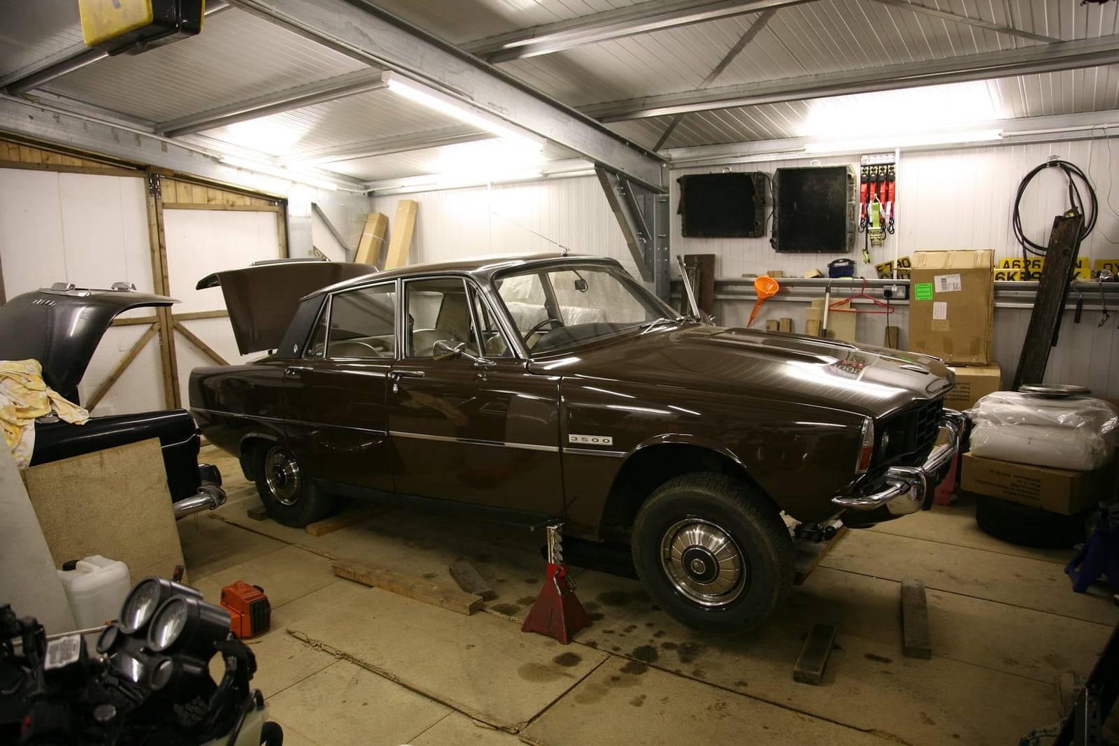 A brown Rover P6 3500 V8 in a home workshop garage