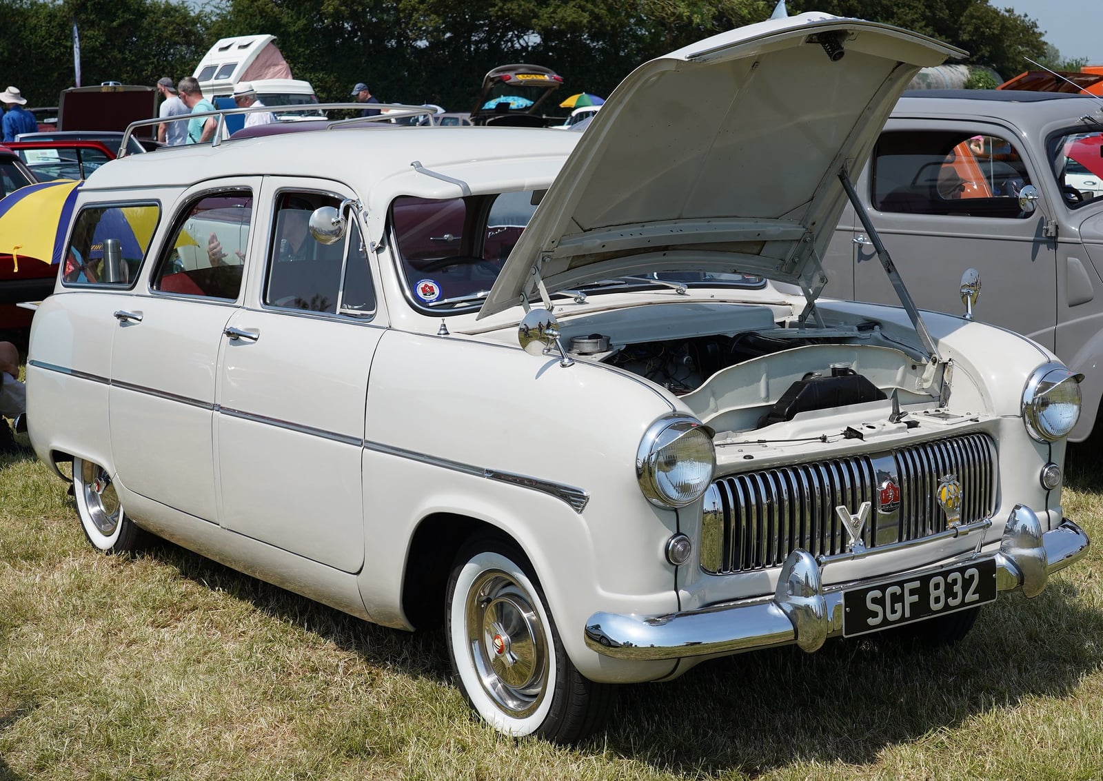 A cream Ford Consul Mk1 estate with the bonnet raised, at a show