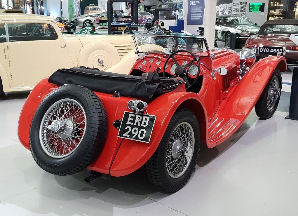 A red SS Jaguar 100 open sports car, rear three-quarter view, UK registration ERB 290