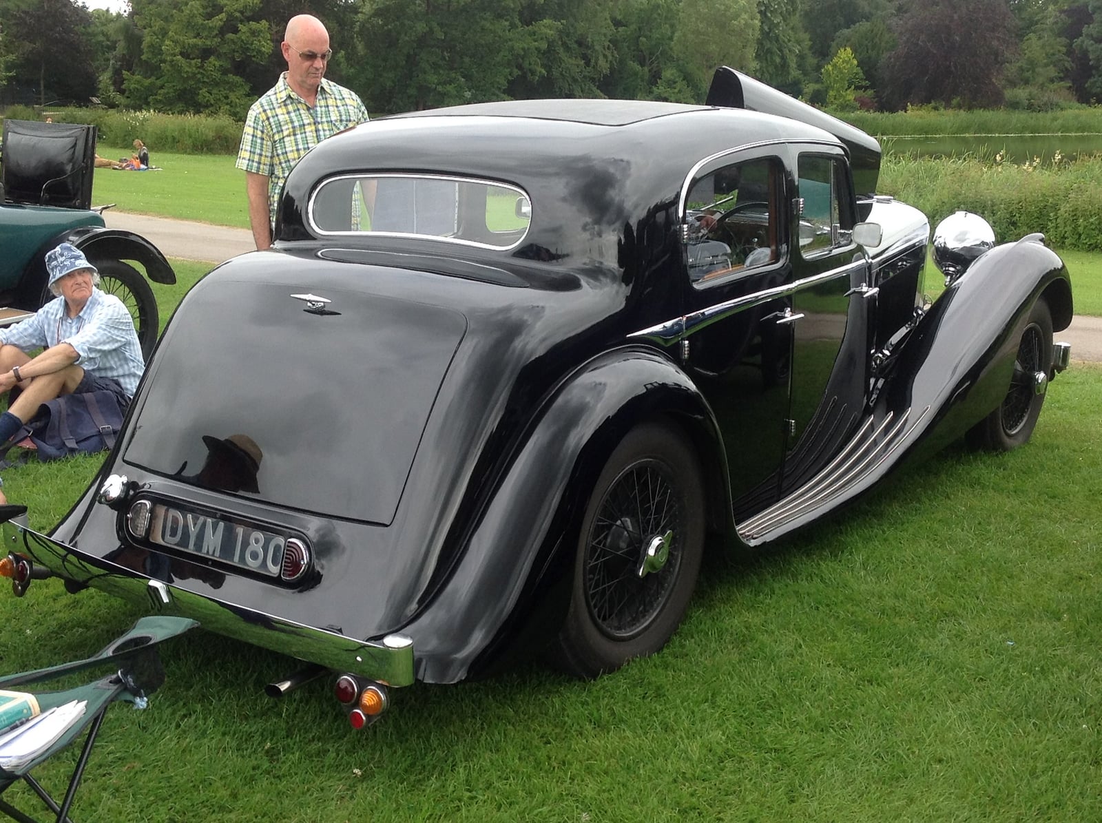 A grey SS Jaguar 2.5-litre saloon of 1937, rear three-quarter view at a show