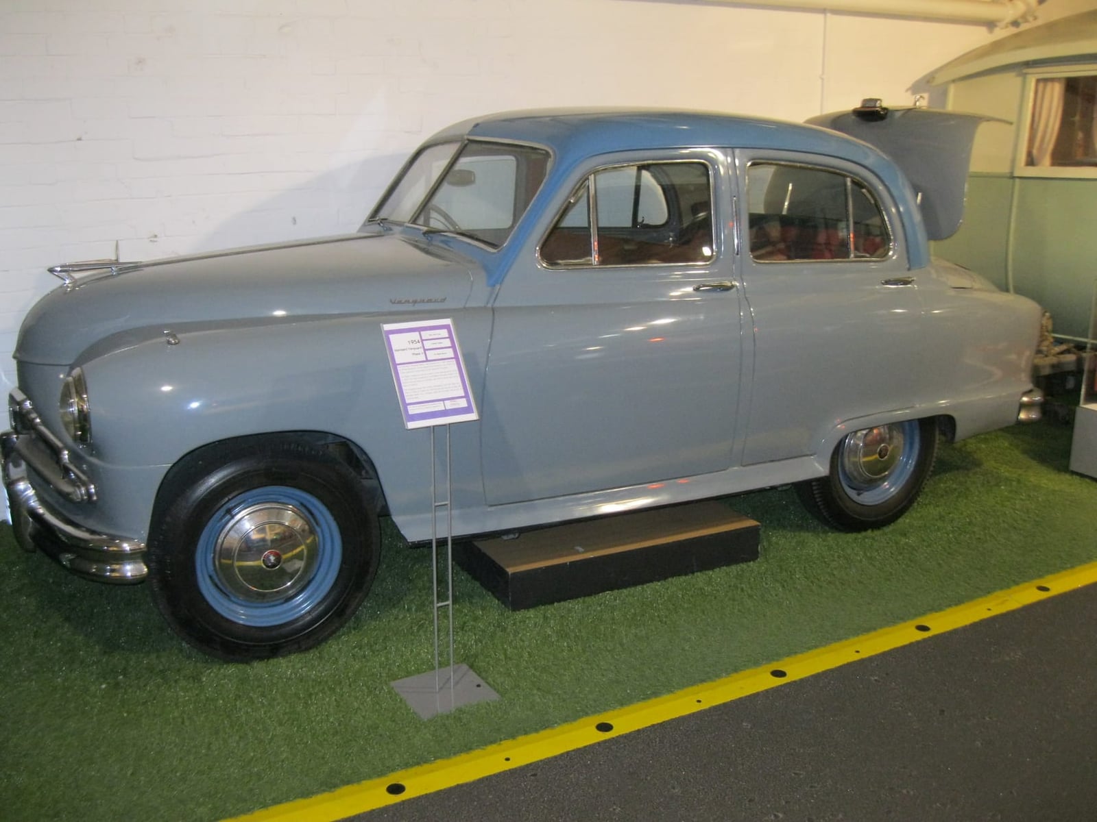 A pale blue Standard Vanguard Phase II displayed in a museum, side view showing the notchback rear