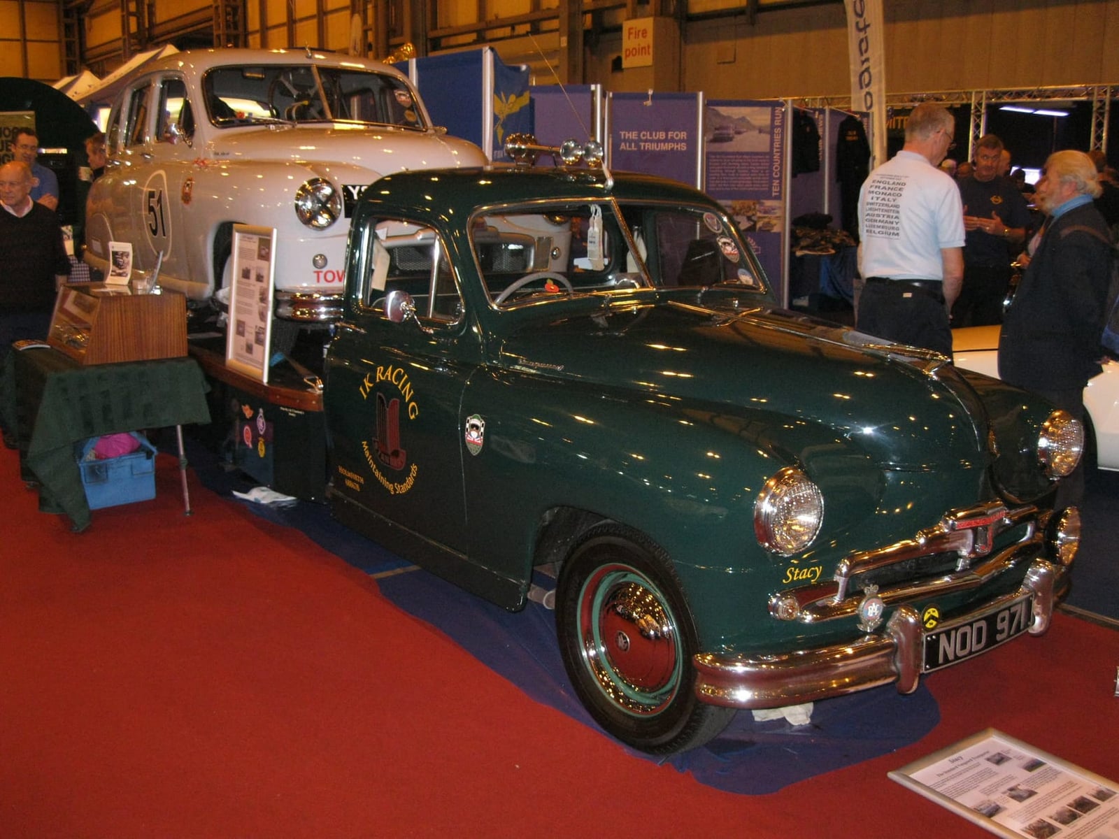 A dark green Standard Vanguard on an owners club stand at an indoor classic car show, UK registration NOD 971