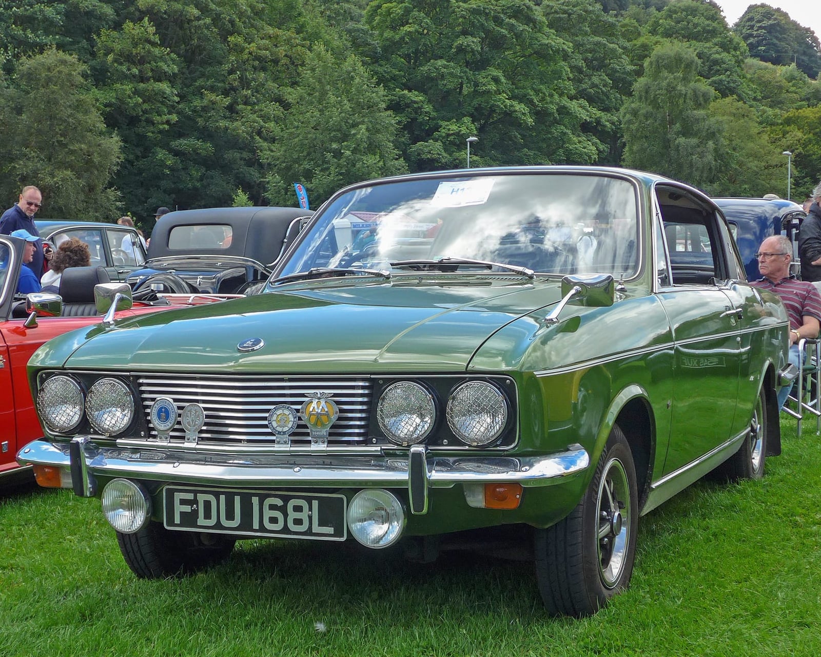 A green 1972 Sunbeam Rapier fastback on grass, front view, UK registration FDU 168L