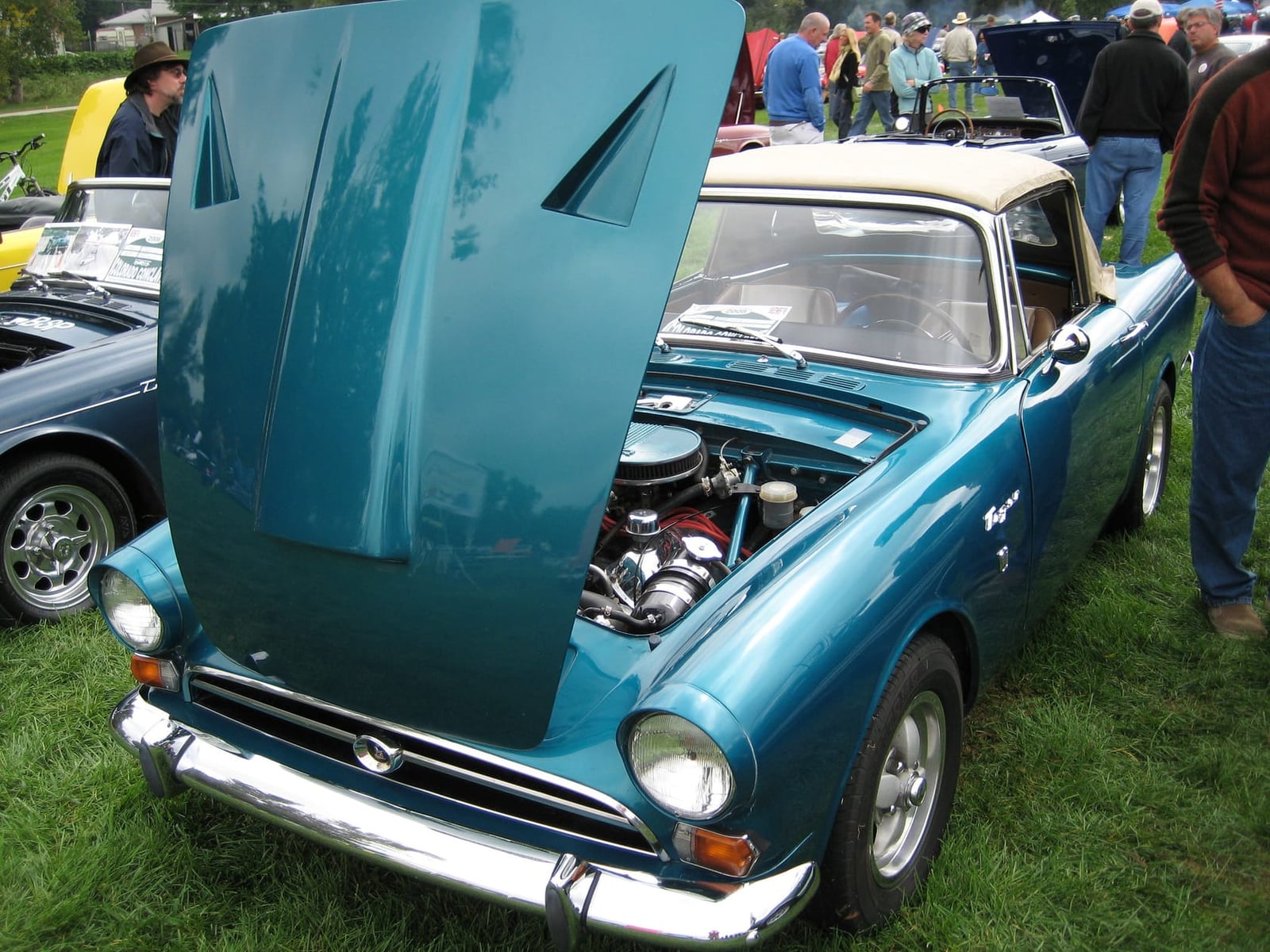 A blue Sunbeam Tiger Mk I with its bonnet raised, showing the Ford 260 V8 filling the engine bay