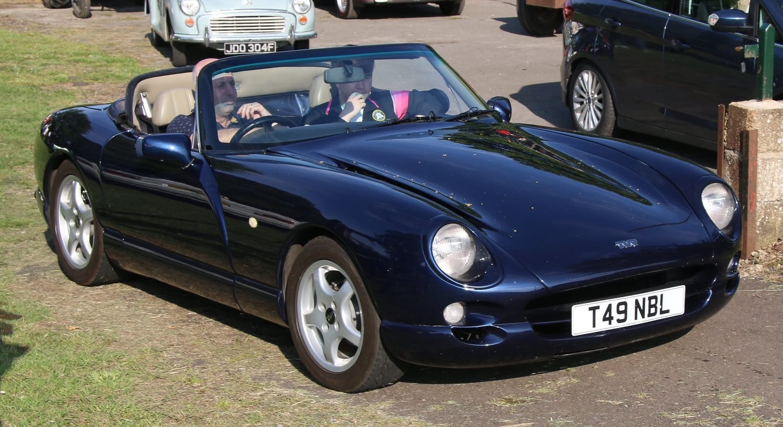 A dark blue TVR Chimaera parked at the kerb on a street, front three-quarter view, UK registration T49 NBL