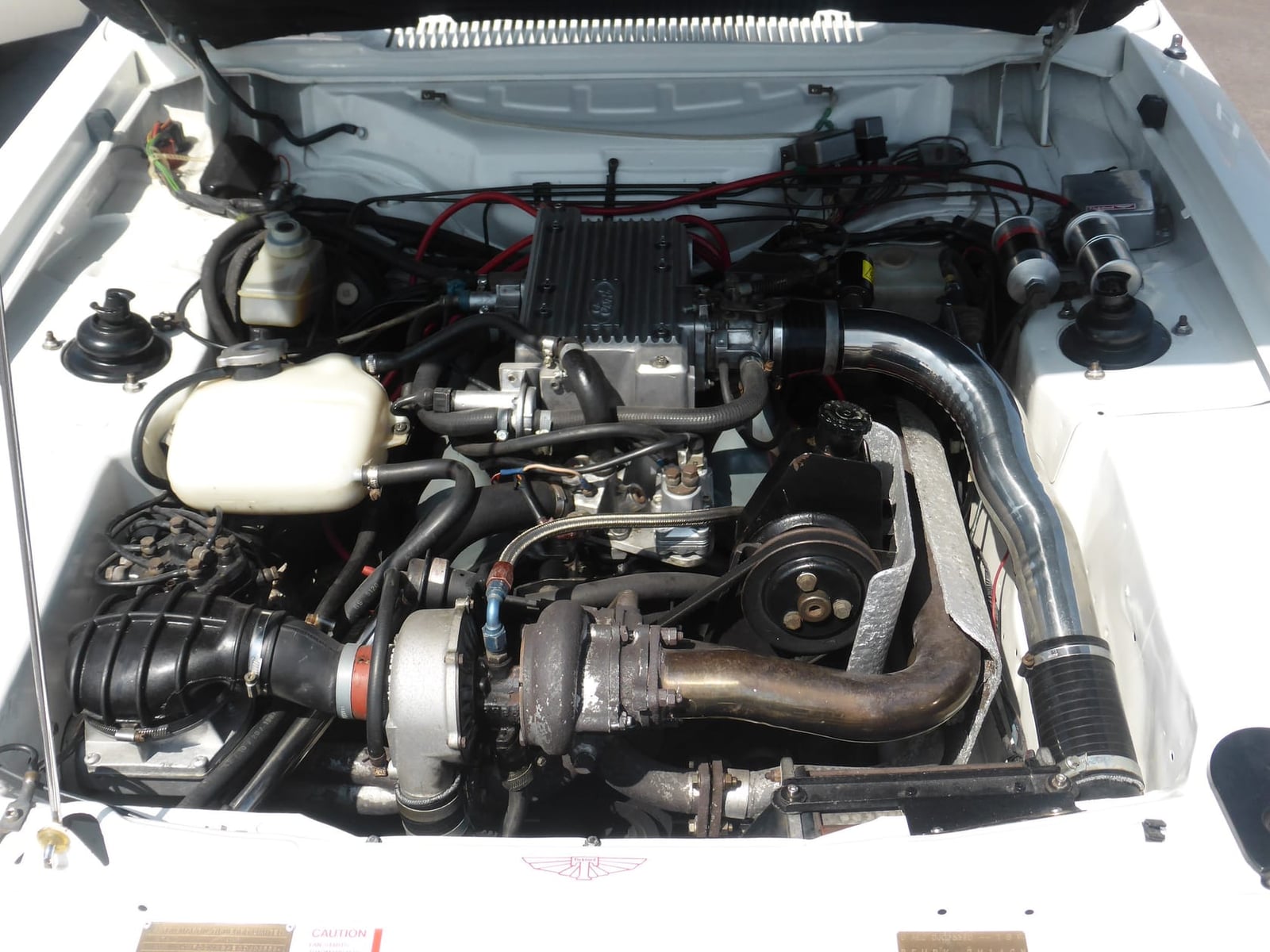 The engine bay of a 1984 Tickford Capri, showing the turbocharged 2.8 V6 and its intercooler plumbing