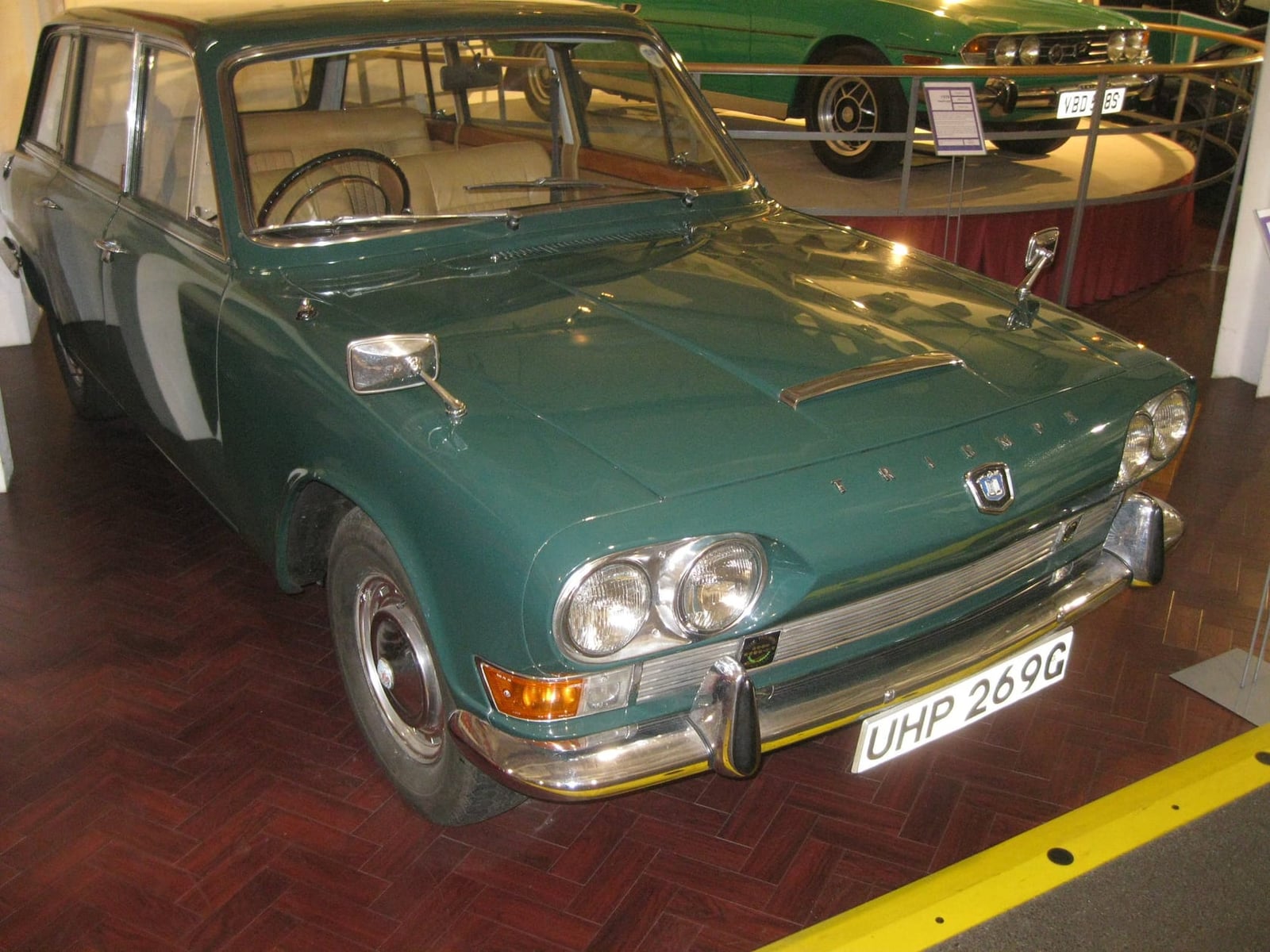 A green Triumph 2000 estate displayed in a museum