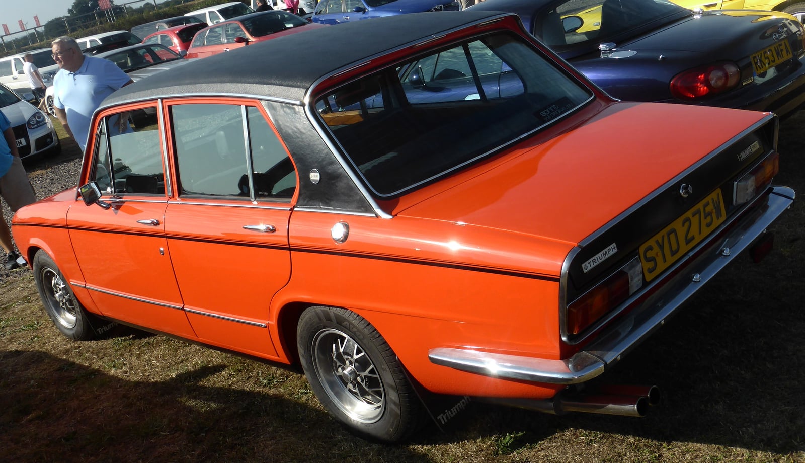 An orange Triumph Dolomite Sprint, rear three-quarter view showing the twin exhausts and Sprint badge