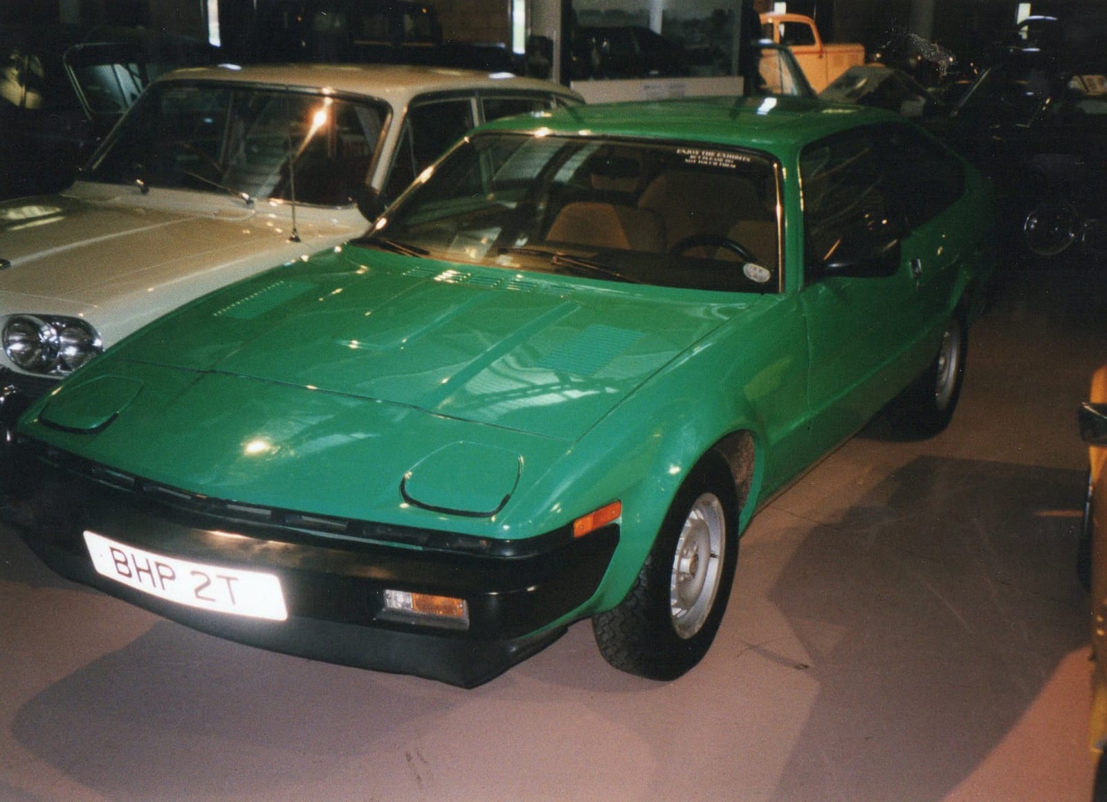 A green 1978 Triumph Lynx prototype, a fastback coupe based on the TR7, on an indoor museum display, UK registration BHP 2T