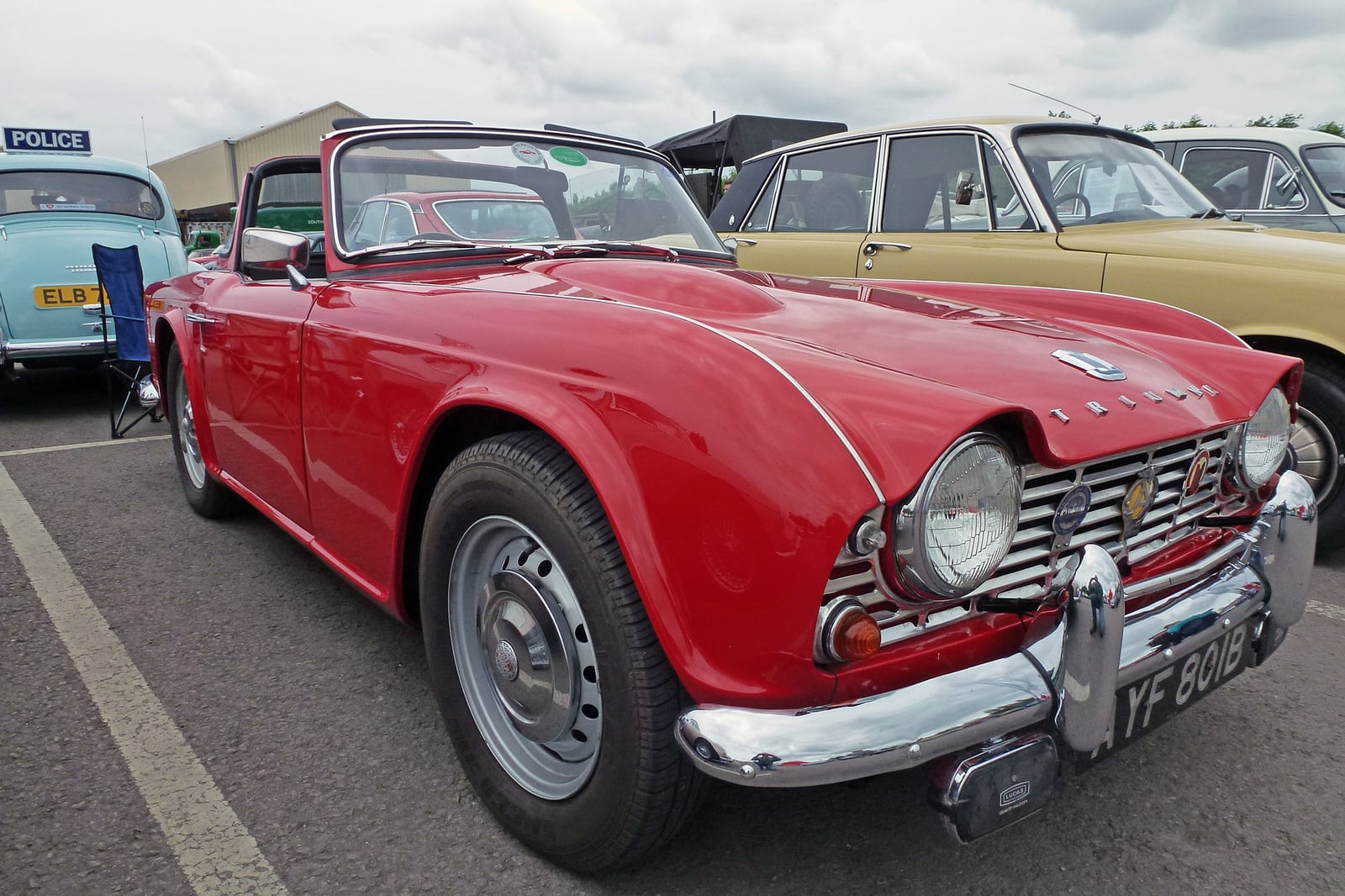 A red Triumph TR4, front three-quarter view