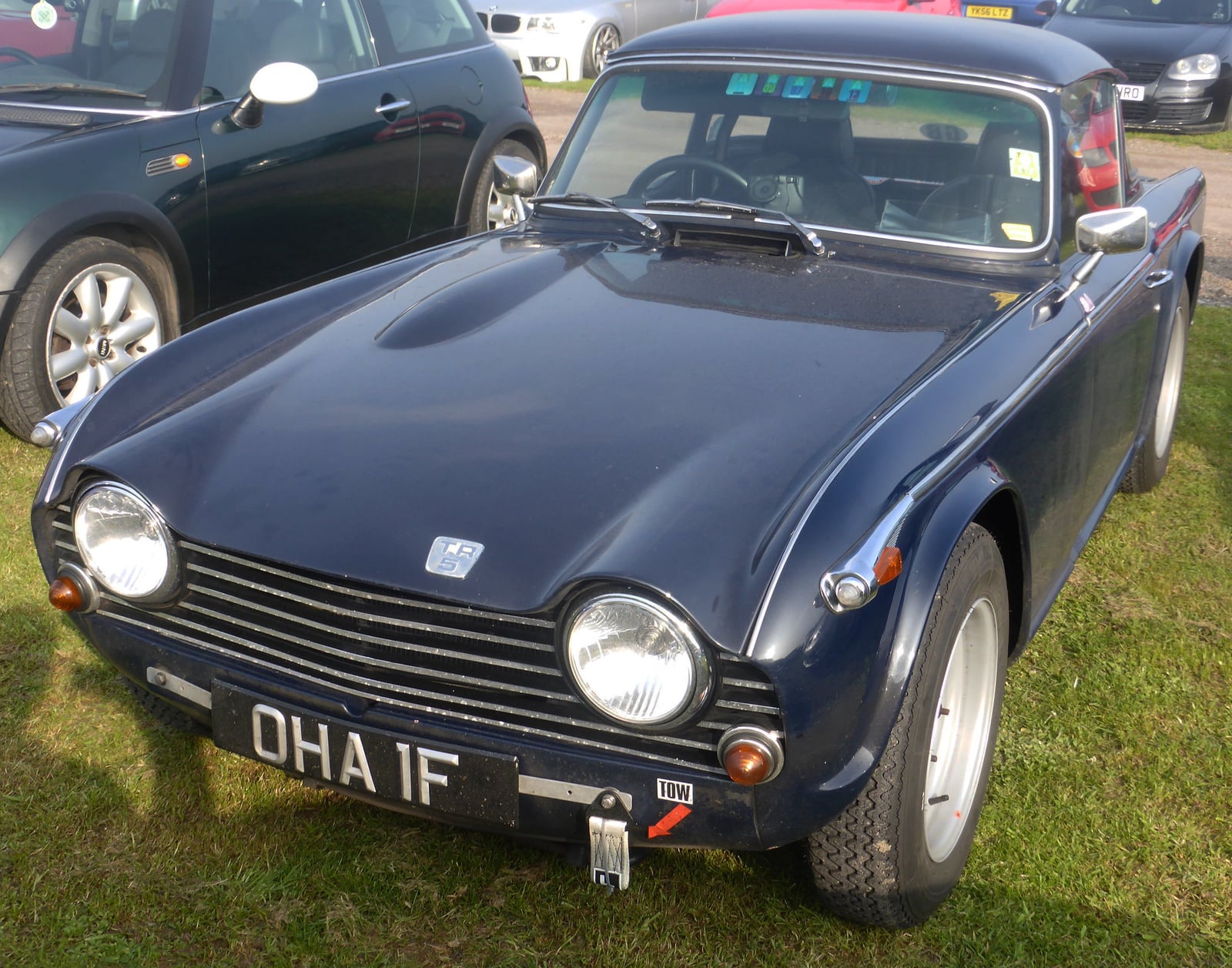 A dark blue Triumph TR5 PI, UK registration OHA 1F, front three-quarter view at a show