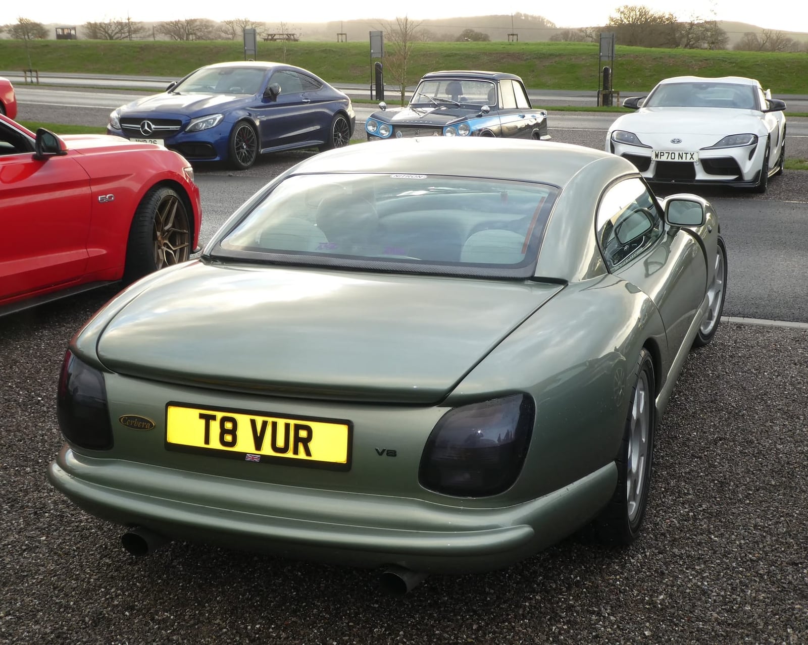 The rear view of a green 1999 TVR Cerbera with UK registration T8 VUR
