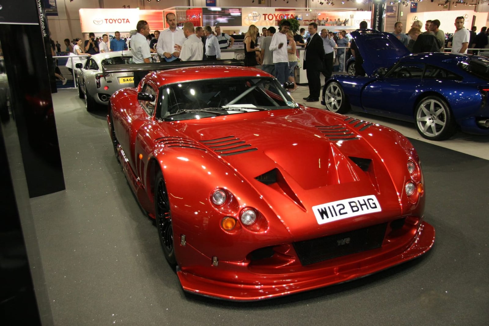 The red TVR Cerbera Speed 12 with UK registration W112 BHG displayed at a motor show