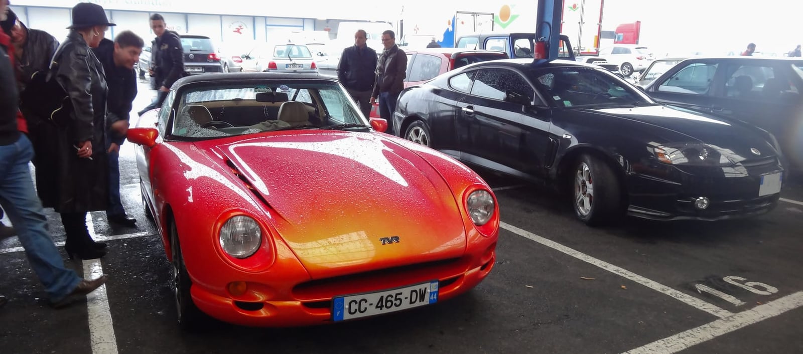 A red 2003 TVR Cerbera V8 parked at a European car meeting
