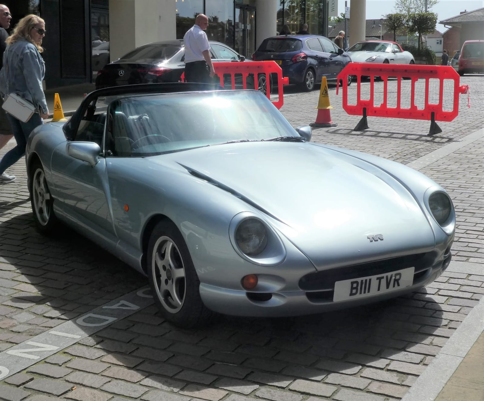 A red TVR Chimaera on display at an indoor classic car show, front three-quarter view