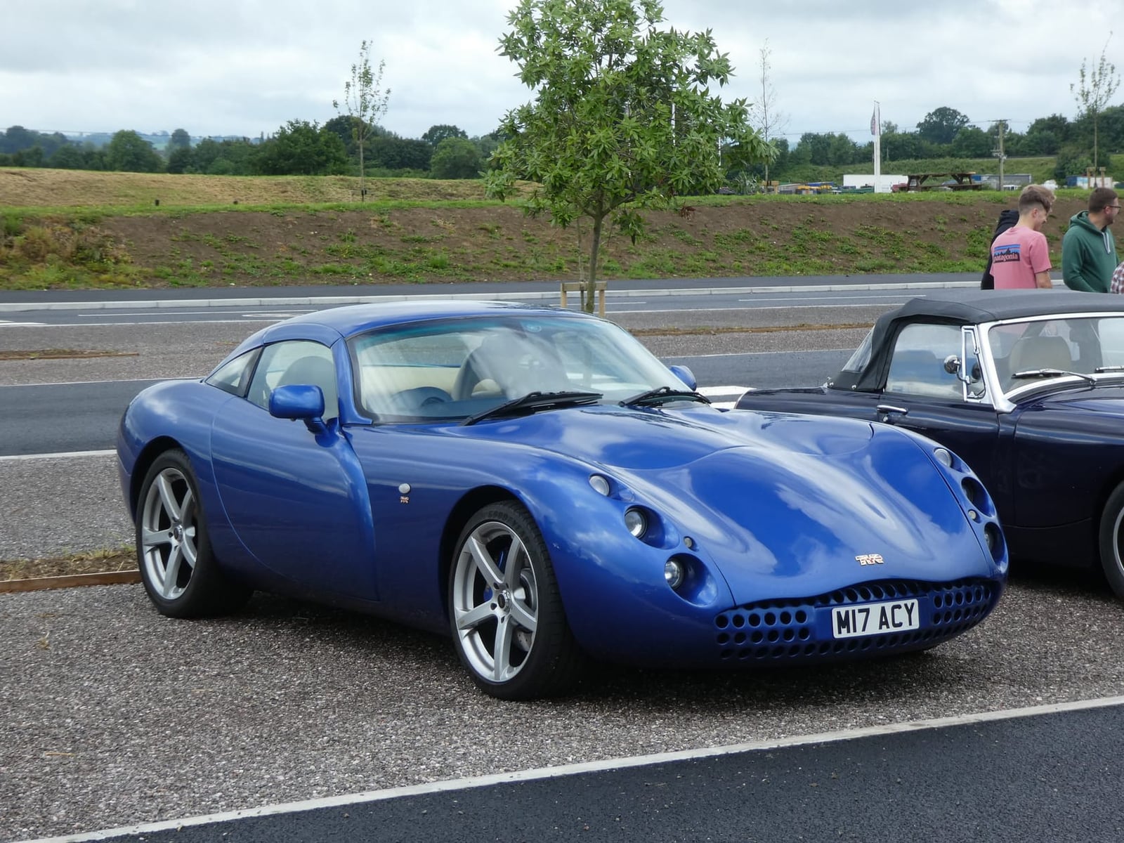 A blue 2001 TVR Tuscan Speed Six in profile at a car gathering