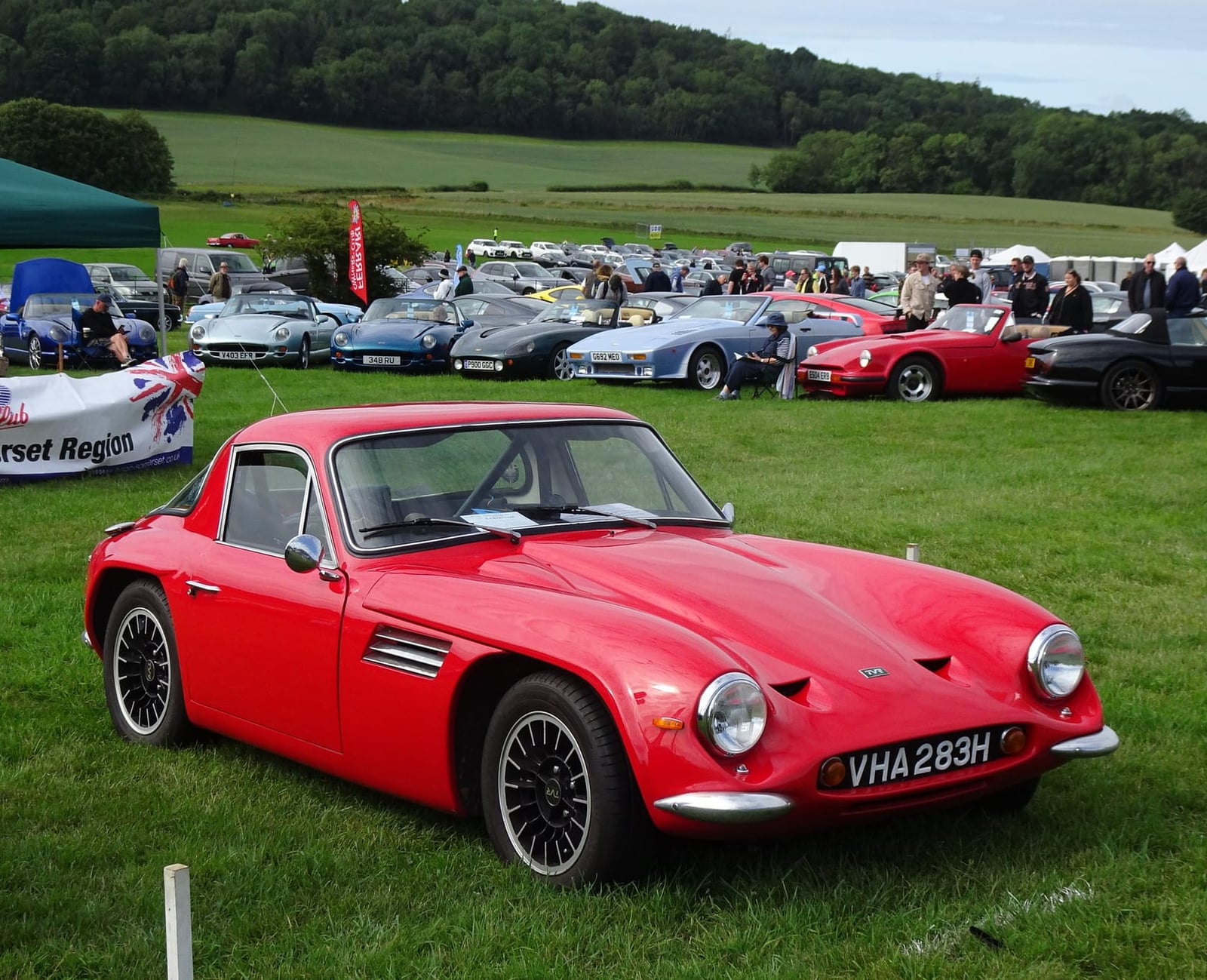 A red 1969 TVR Vixen 1600 with UK registration VHA 283H on a show field