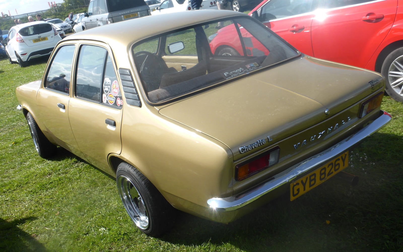 A gold Vauxhall Chevette L Saloon (1982), rear three-quarter view at an outdoor classic car show