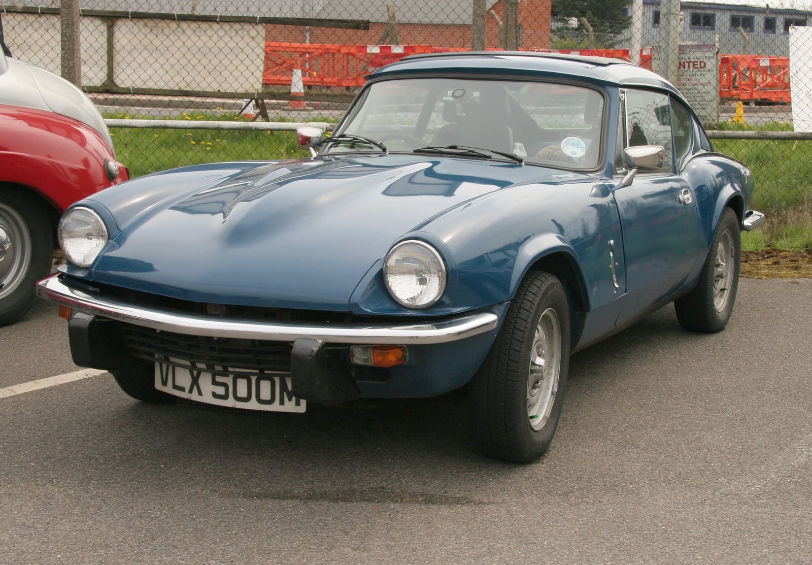 A blue Triumph GT6 Mk3 fastback coupe, front three-quarter view