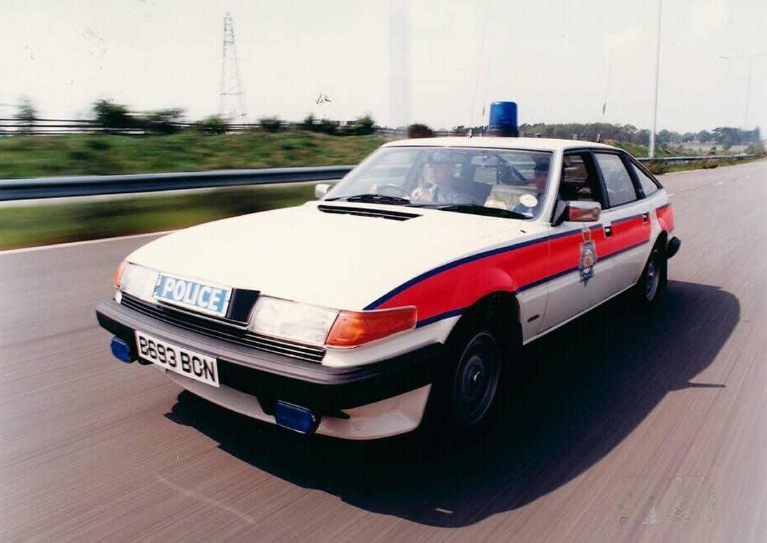 A white West Midlands Police Rover SD1 traffic car in jam-sandwich livery travelling at speed on a motorway, UK registration B693 BCN