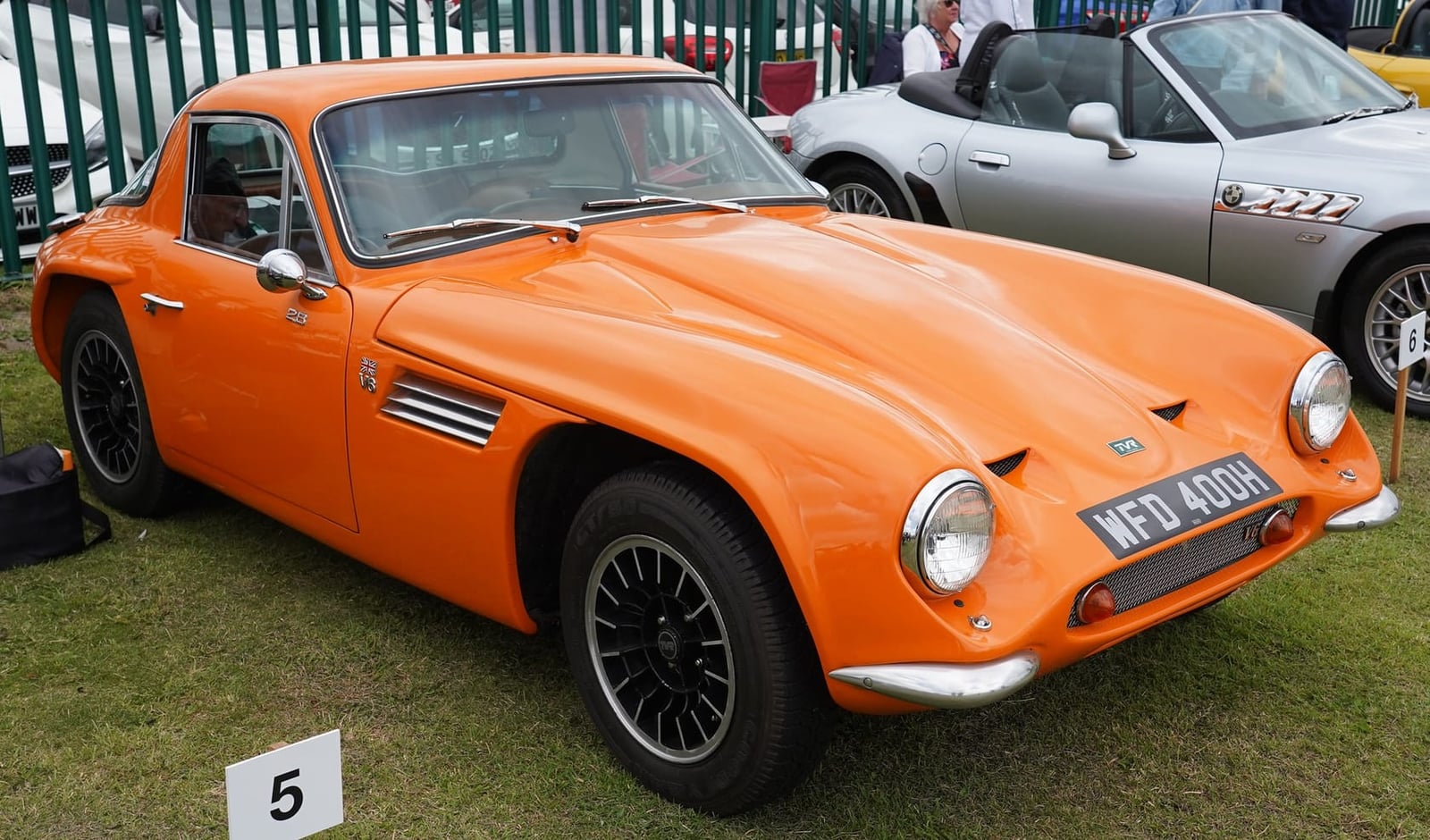 An orange TVR Vixen S2 with UK registration WFD 400H and bonnet open at a show