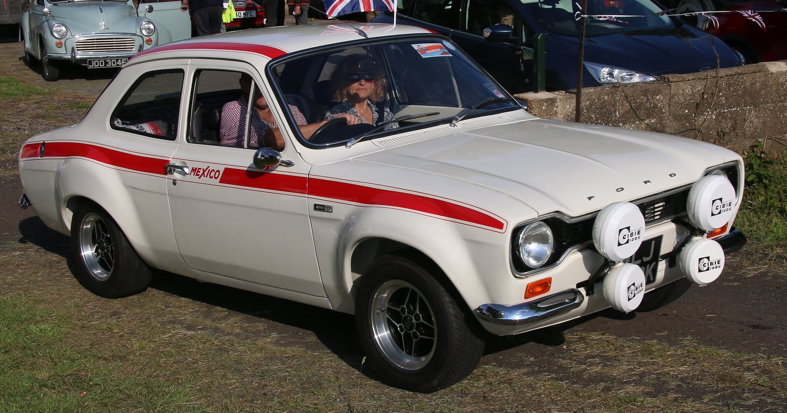 A white Mk1 Ford Escort Mexico with a red stripe, side view