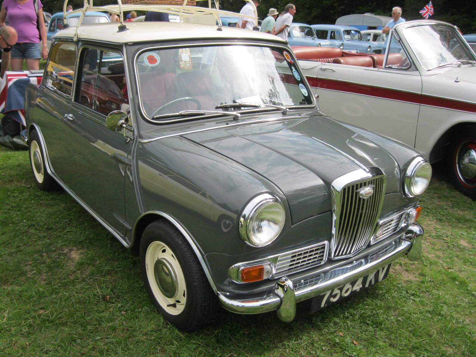 A grey-green Wolseley Hornet saloon at a show, front three-quarter view